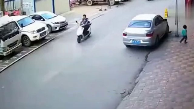 小孩在马路上奔跑，被路过三轮车撞倒后，监控拍下令人愤怒的一幕