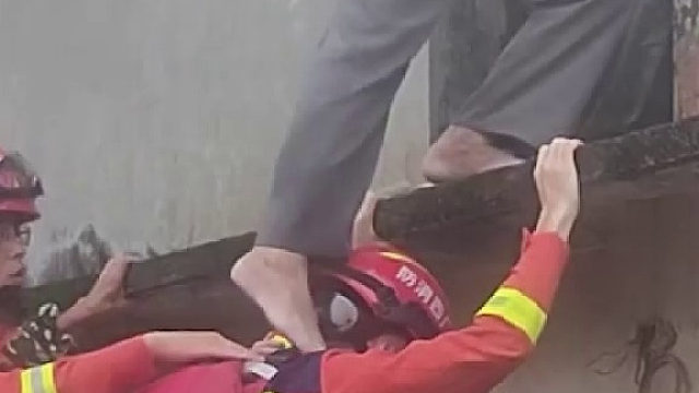 消防员用身体充当“梯子”转移被困老人
