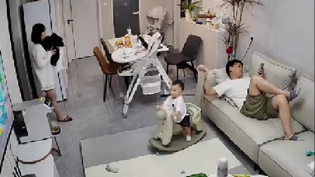 爸爸在客廳一邊玩手機一邊帶孩子，沒想到下一秒孩子不見了
