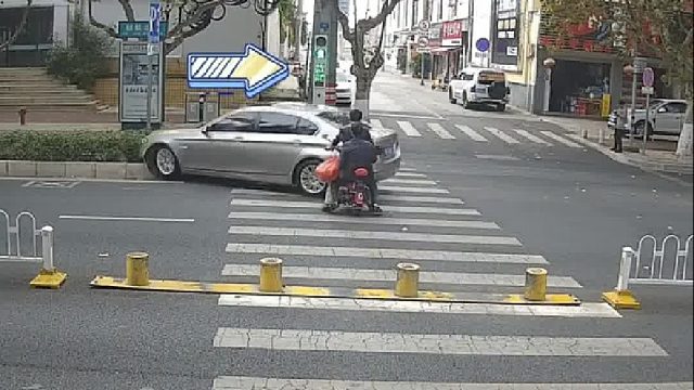 一辆小轿车闯红灯，避让不及撞上丝带！