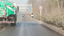 洒水车无视旁边女子作业，女子一路躲避被逼绿化带逃过一劫