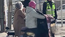 女子不带头盔骑电瓶车偶遇交警，默默拿出一个塑料袋套在头上，并且挖出了眼睛鼻子的孔……