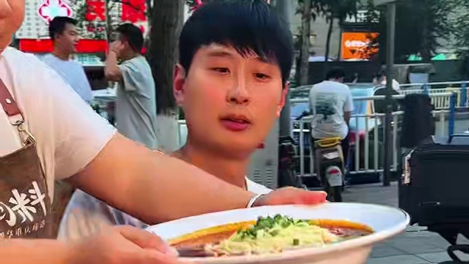 帅哥看到别人吃得轻松也来挑战，结果发现还是有点难度，围观大哥忍不住给他加油#美食 #这一碗好过瘾 #