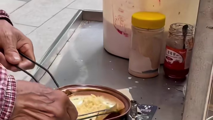 在成都的街头偶遇一位爷爷在角落里卖蛋烘糕，菜单上有十几种味道还可以两两搭配，听本地朋友说蛋烘糕最好吃的就是甜咸搭配，我选了肉松加奶油。蛋皮刚烤出来外焦里嫩，还热乎乎的，包裹着奶油肉……