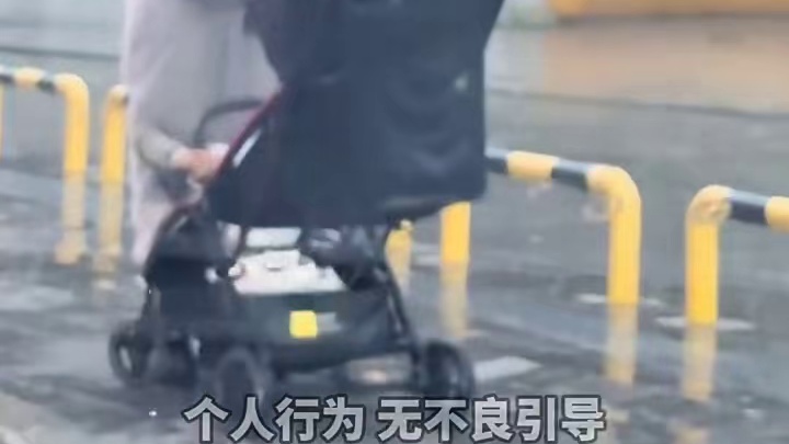 突然开始下大雨，妈妈用身体为婴儿车里的孩子挡雨