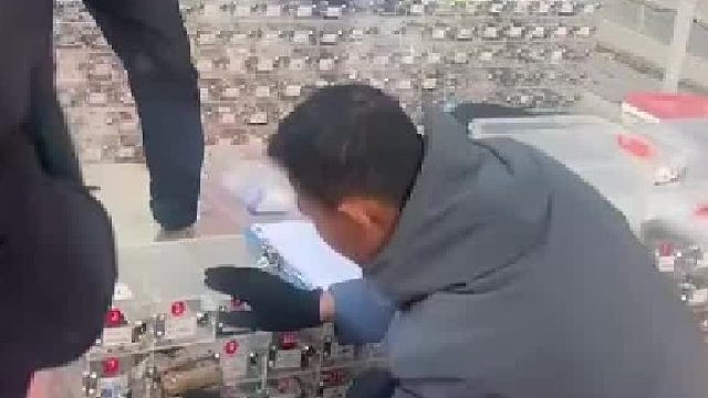 男子在学校门口摆摊做生意，专门替别人保管手机