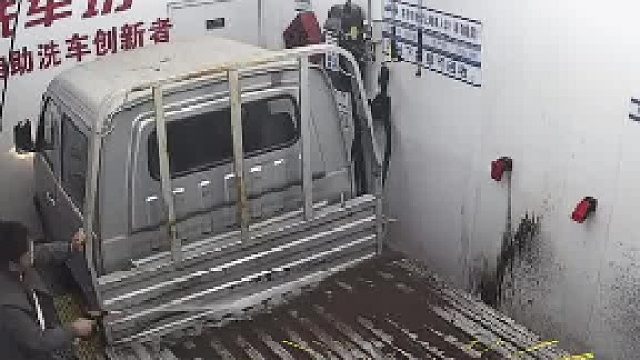 自助洗车时把墙面弄脏，老板看着监控正生气时，男子站到车上把墙面给冲洗干净