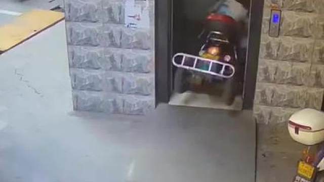 老人骑三轮车撞破电梯轿厢门